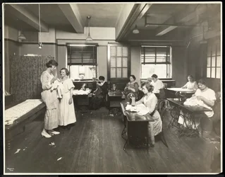 Blind young women and a teacher sewing in a classroom at the New York Association for the Blind, 111 East 59th Street, New York, 1921