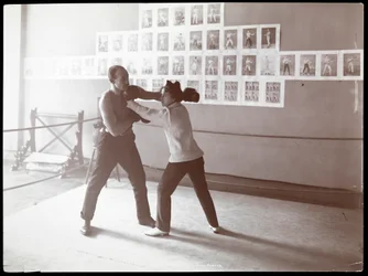 Edna Wallace Hopper posed in a boxing ring with Jack Cooper at his gymnasium at Broadway and 37th Street, New York, 1899