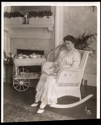 Mrs. Howard Seated with a Book in a Rocking Chair at Her Home at 200, 5th Avenue, New York, 1915-6