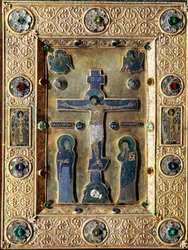 Evangelical of gold and enamel decorated with gold leaves repels with filigree crucifix representing the Virgin and Saint John
