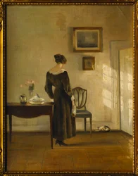 An Interior with a Woman feeding a Cat