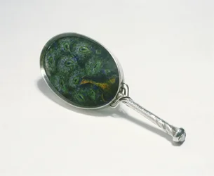 Hand mirror designed by Ashbee with peacock design enamelled by William Mark, made by the Guild of Handicraft, 1903
