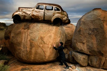 Man Pushing Car Boulder