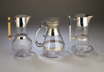 Silver mounted claret jug; electroplate mounted claret jug with aesthetic style decoration to mounts; silver mounted claret jug, all manufactured by Hukin & Heath
