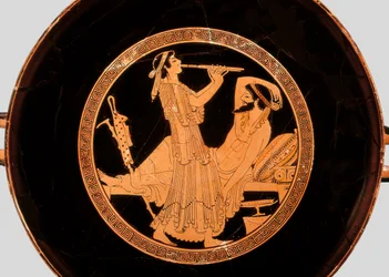 Banquet and double flute player (Detail from kylix or Attic red-figure cup, c.490 BC)