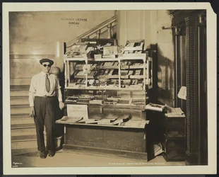Blind news dealer, John Martie, at his stand at the south end of the Municipal Building, New York