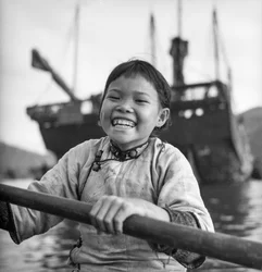A portrait of a young girl in a sampan in Aberdeen harbour, Hong Kong