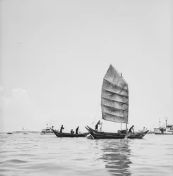 A Sampan Under Sail and One Being Skulled in Penang Harbour