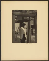Black Man Standing Under a Bell