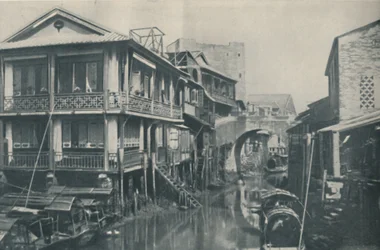 Fouled Waters Beneath a Bridge Leading to Unlovely Homes of Poverty and Pain