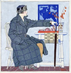 Young woman sitting beside table holding umbrella