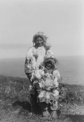 A young child and an older Eskimo wearing duck skin parkas, Nunivak Island, Alaska, c.1929