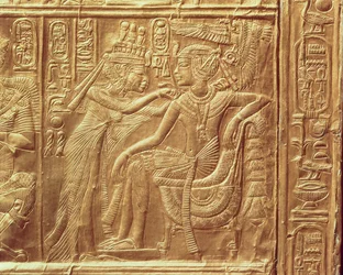 Detail from the little shrine of Tutankhamun depicting the Queen fastening a necklace round the king