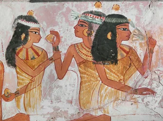 Ladies offering a lemon and a mandragora root to another lady during a banquet