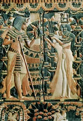 Plaque from the lid of a coffer showing Tutankhamun and his wife Ankhesenamun in a garden