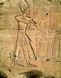 Relief depicting Tuthmosis III making an offering to a seated god