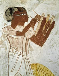 Scribes with reed pens measuring and recording the harvest