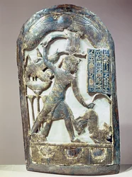 Votive shield depicting the king slaying a lion, from the tomb of Tutankhamun