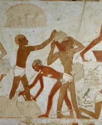 Workmen loading and carrying materials