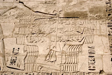 Detail of the reliefs of the first pylon representing the capture of fighters belonging to the peoples of the sea, enemies of Ramses III. Funeral Temple of Ramses III, Luxor, Medinet Habou, Egypt