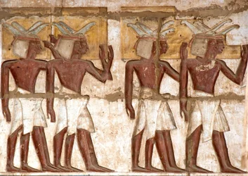 Egyptian antiquity: first court, detail of painted reliefs representing a group of Nubians bringing offerings to the pharaoh. Funeral Temple of Ramses III