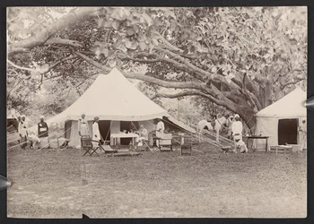 J.J. Cotton in topi and tent (b/w photo)