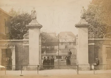 Children Standing Looking Through the School Gate