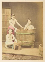 Japanese Girls Bathing, Studio tableau of three half-naked young Japanese women, posed in and around a circular wooden bath tub, Photographer: Unknown, Lucas Collection: Photographic record of the world tour of Charles James and Morton P. Lucas