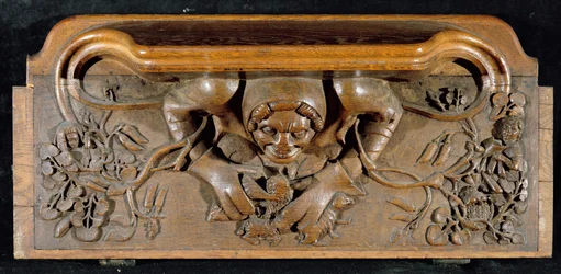 A misericord depicting an ogre with enormous shoulders, New College Chapel, Oxford, late 14th century