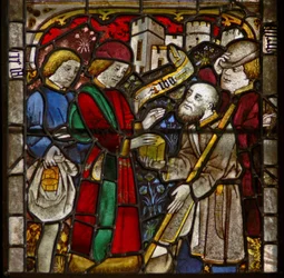 A panel in the east window depicting the Works of Mercy: feeding the hungry