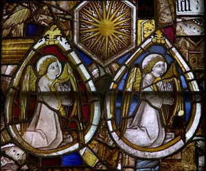 A panel in the east window depicting two musician angels with harps and a sunburst, emblem of Edward IV