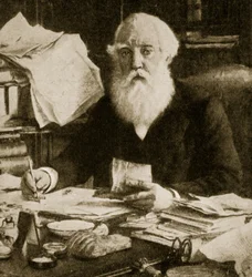 Austen Henry Layard sitting at his desk