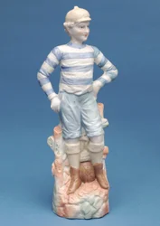 Bisque figure of a boy footballer in blue and white striped kit (ceramic)