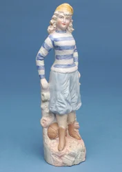 Bisque figure of a girl footballer in blue and white striped kit (ceramic)