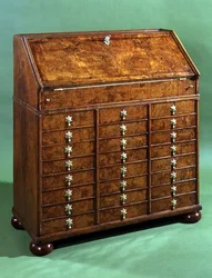 Bureau with many small drawers and bun feet