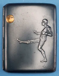 Cigarette case with a footballer kicking a gold ball into the air (metal)