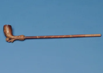 Cup tie pipe with bamboo stem and carved boot kicking a ball underneath (clay)