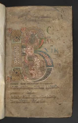 Large initial with beast-head terminals, interlace and foliate decoration in pink, orange, yellow, green and blue