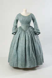 Light blue flowered silk dress with shaped pointed bodice and long full sleeves