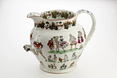 Staffordshire jug decorated with Harlequin figures and carnival theme, 1866