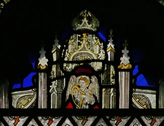 Window depicting a canopy with a musical angel