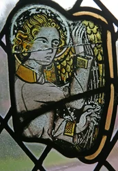 Window in the Cloisters depicting a musician angel with a harp
