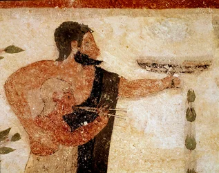 A bearded man presenting a cup, near him a musician (detail)