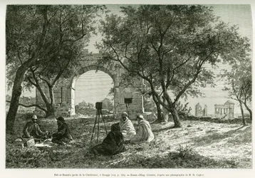 Bab-er-Roumia (Bab er Roumia), gate of the Christian woman, Roman ruins in Dougga, picnic of travelers and their guides, around a camera. Engraving by Eugène Girardet, to illustrate the story “Voyage en Tunisie”, by R. Cagnat and H. Saladin, charges of an