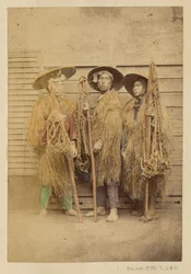 Three Japanese Men in Grass Robes and Wide-Brimmed Hats