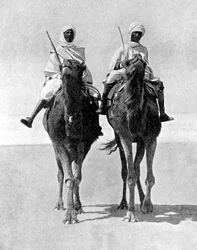 Two Arabs riding camels in the Sahara Desert, Africa, 1936