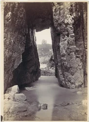 View Through Rocks of Tower on Hill