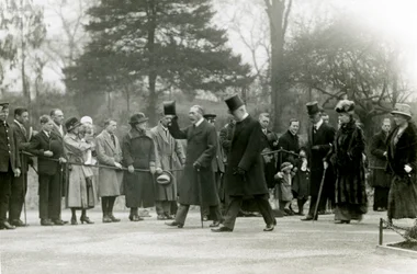 King George V raising his hat to the crowds at the front of his entourage, during a visit to London Zoo to officially open the Aquarium, April 1924