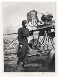 Helene Dutrieu standing beside a plane