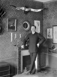 Portrait of a Young Man, Posing in the Living Room Decorating the Abbey of Septfontaines, Near Bourmont en Haute Marne. Photography Late 19th Century. Ducos Collection